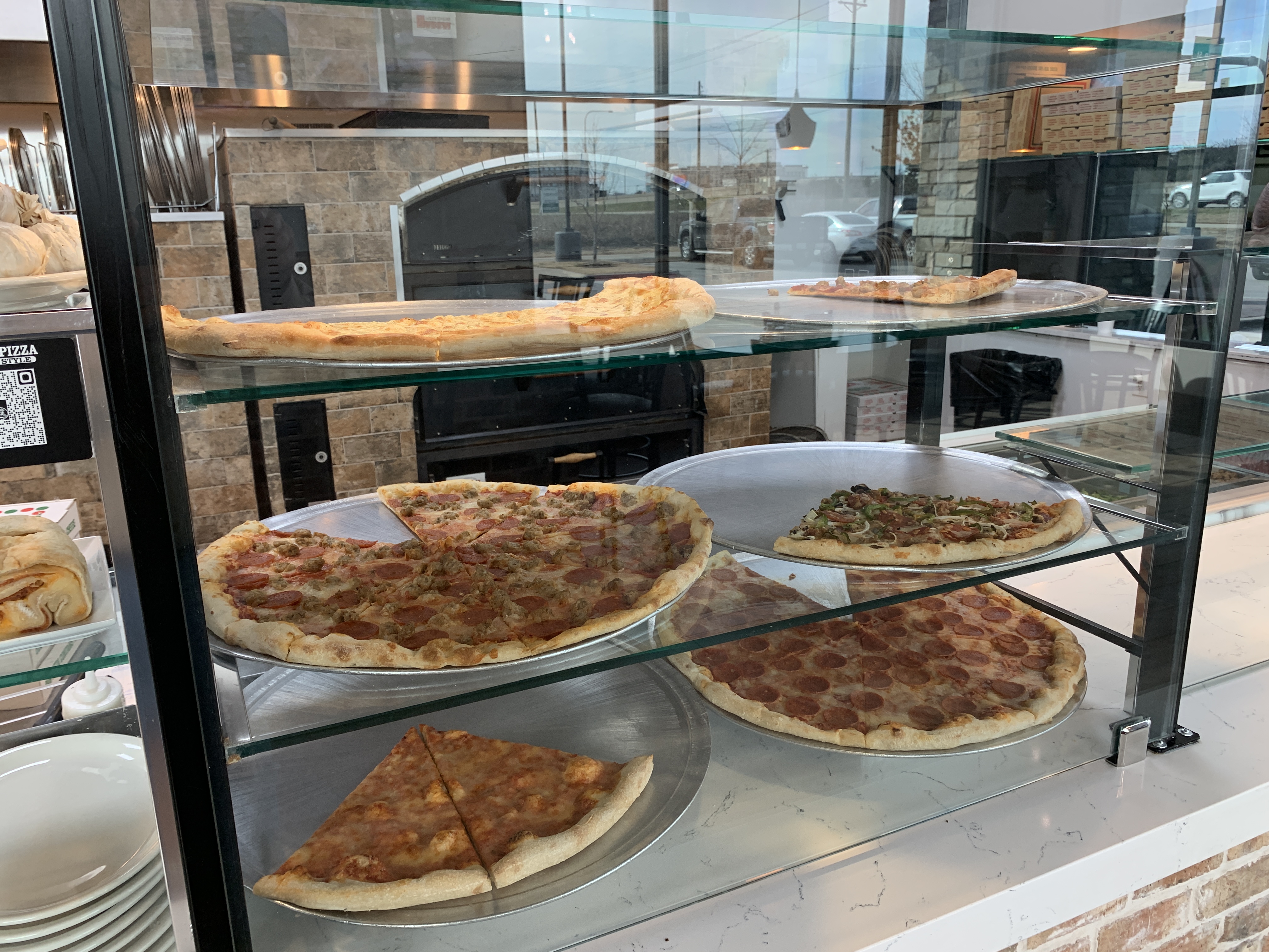 Hand-tossed pizza served at Jonny's Pizza in Frisco, Texas