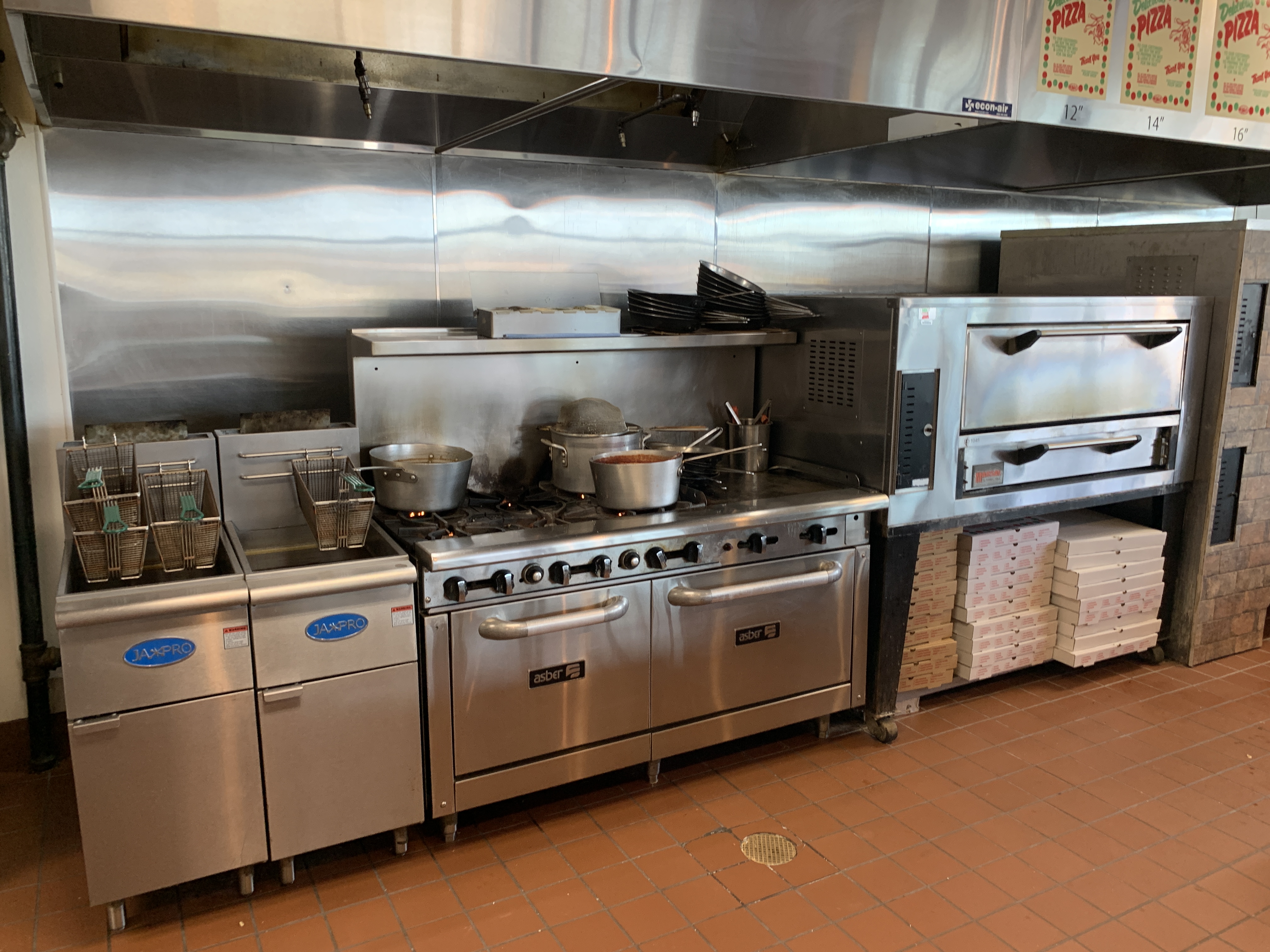 Kitchen range and pizza ovens where sauces and dough are prepared at Jonny's Pizza in Aubrey, TX