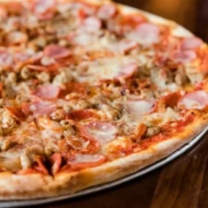 Meat Lovers pizza with pepperoni, sausage, and ham at Jonny's Pizza in Aubrey and Frisco, TX