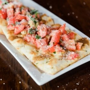 Bruschetta flatbread with diced tomato and basil at Jonny's Pizza in Aubrey and Frisco, TX